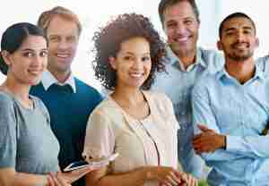 Group of 5 professional people smiling together.
